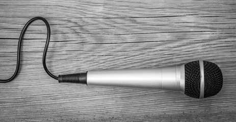 Classic dynamic microphone on a wooden background