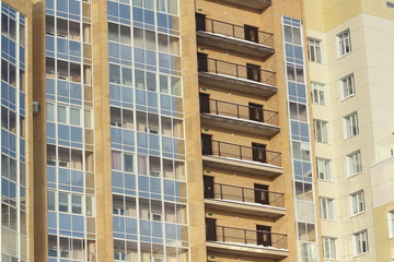 Plastic windows in a modern tiled brick high-rise house.