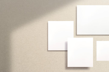 Mood-board composition, boards of inspiration, stories and portraits template with blank photo cards soaring in the air over the coffee colored paper. 