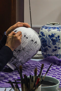 Delft, the Netherlands, Holland,January 18, 2020. The process (stages) of decorating (painting) a traditional blue vase on Royal Delft, the black paint turns traditional blue after baking in the oven