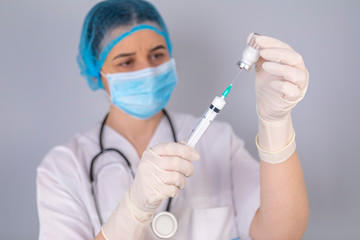 Doctor hands filling the syringe with vaccine