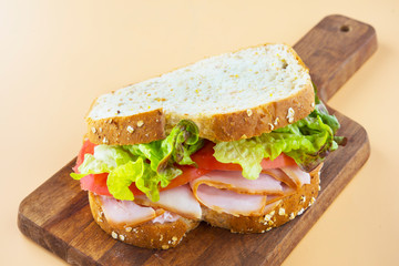 Sandwich of tomato, lettuce and smoked turkey