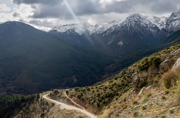 Naklejka premium Country road in the highlands (Greece, Peloponnese) on a winter, snowy day