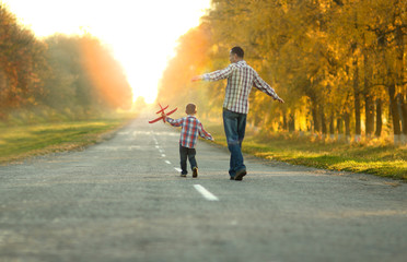 father and son walk in nature - obrazy, fototapety, plakaty