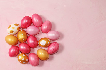 Decorated golden easter eggs on a pink background. Minimal holiday concept. Happy easter...