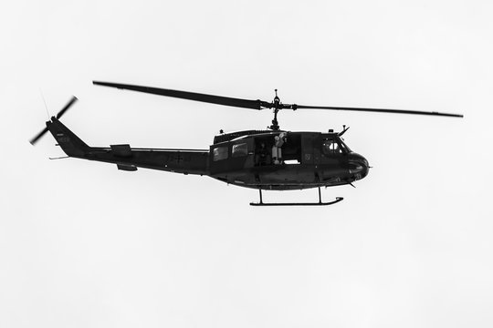 BERLIN, GERMANY - JUNE 02, 2016: Demonstration flight of military helicopter Bell UH-1 Iroquois. German Army. Black and white. Exhibition ILA Berlin Air Show 2016