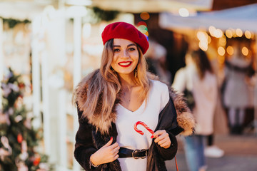 Beautiful young girl in a festive setting. In the circle of it flickering lights. Charm adds her...