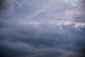 Dark heavy clouds after the rain has formed a divine gap of light and sun.