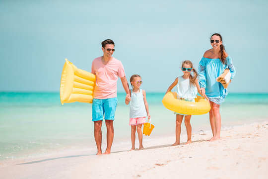 Happy beautiful family with kids on the beach