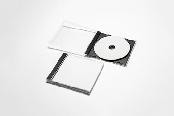 Open and closed compact plastic disc box case with white isolated blank for branding design. CD...