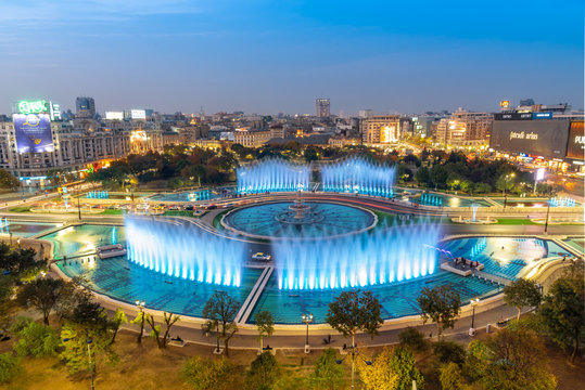 Bucharest, Romania - October 12, 2018: Aerial view of the famous city fountain illuminated by lights and multimedia show in Bucharest capital at dusk to down