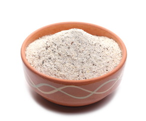 Buckwheat integral flour in clay pot, bowl isolated on white background 