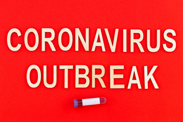 Сoronavirus outbreak. Text in wooden letters on a red background