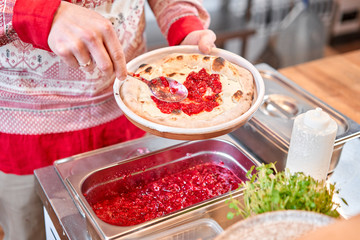 Fruit pizza. Pizza with raspberries, mascarpone and mint leaves. Traditional wood oven in restaurant, Italy. Original neapolitan pizza. Red hot coal.