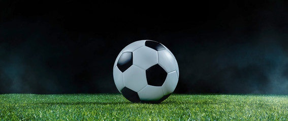 Traditional football on an illuminated sports field at night