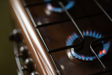Burning blue flame of gas on the stove. Gas-burner