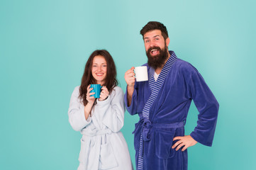 Vacation starting here. Hotel breakfast service. Coffee is our tradition. Man and woman happy together. Family traditions. Couple in cozy bathrobes enjoy lazy weekend. Drinking coffee. Spa and relax