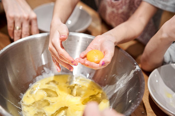 Separate the egg into protein and yolk. Funny master class for children on baking pizza and italian ice cream. Young children learn to cook. Kids preparing homemade pizza. Little cook.