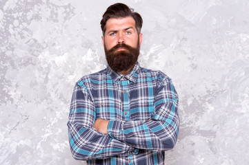 mature guy casual style. confident male hipster after barbershop. professional hairdresser in checkered shirt. brutal bearded man grunge background. serious man with lush beard and moustache