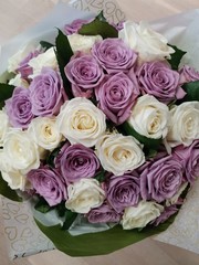 a bouquet of white and purple roses