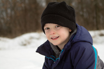 Winter Boy Portrait Against Snow