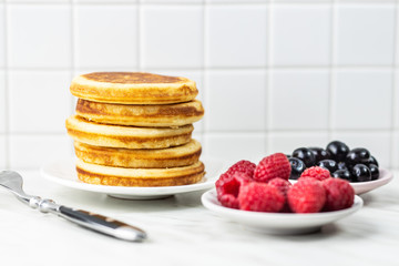 Sweet homemade pancakes with blueberries and raspberries