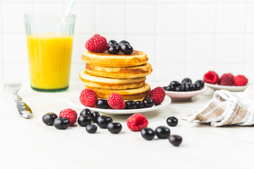 Sweet homemade pancakes with blueberries and raspberries