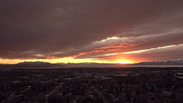 Time lapse panning over Provo city during sunset from mountain side.