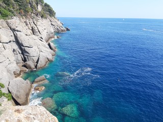 Close-up of big waves breaking on the coast in Liguria, Italy, Europe. White waves of the sea break on the cliff.