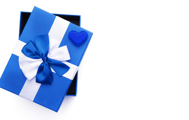 Blue present box and blue heart on white background top view. Greeting card for Valentine's Day