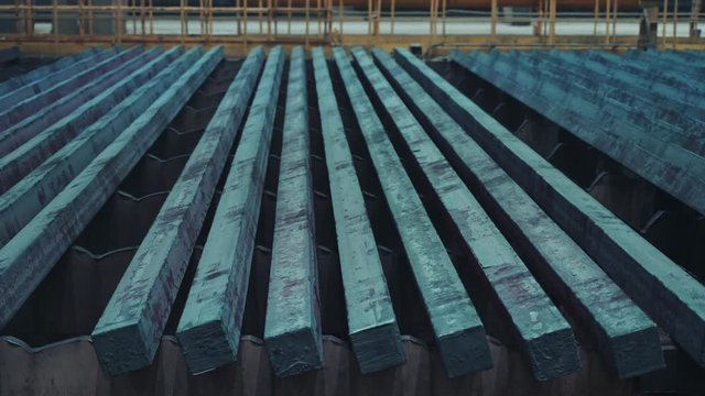 Ready-made steel billets are moving on a manufacturing line at an iron factory