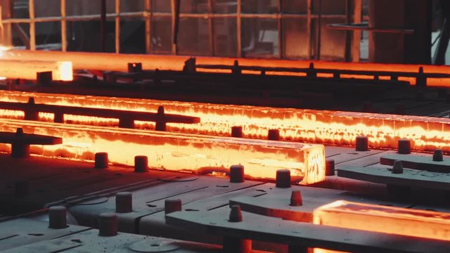 Steel billet moving through the pipeline on iron factory
