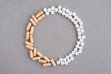 circle wreath made of medical pills and capsules, place for text 