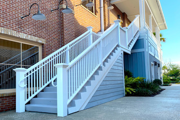 a white outside stairs staircase in a clean alley