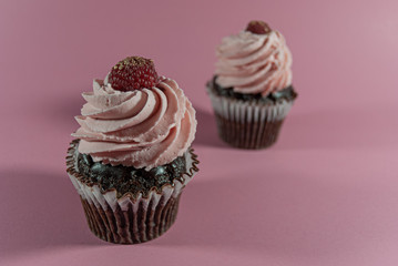 2 Cupcakes on pink backgroun