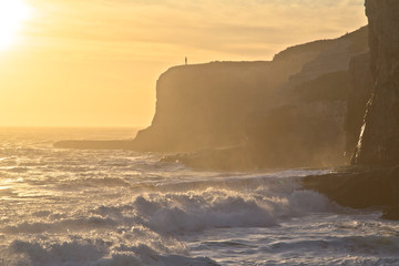 Man on a cliff at sunset © J