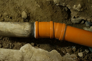 Replacing old cast iron sewer pipe with new pvc pipe.