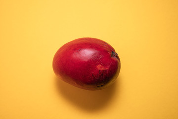 red mango on yellow background