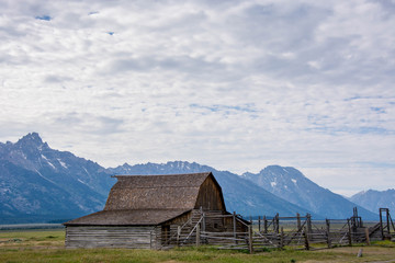 Fototapeta na wymiar john moulton mormon farm in summer against grand teton mountains, blue layers
