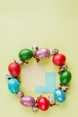 Top view painted eggs Easter Frame in circle shape on a yellow background. Copy space