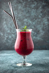 Berry smoothie. On a turquoise background. Cocktail menu. Sea mood concept.