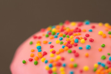 Fototapeta na wymiar Delicious pink donut on black background close-up.