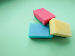 Set of housewives for washing dishes. Dishwasher. Bottle of washing utensils, sponges on background. Top view.