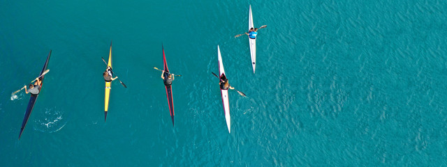 Aerial drone ultra wide photo of women athletes competing in sport canoe in tropical exotic lake