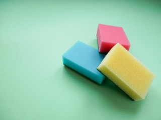 Set of housewives for washing dishes. Dishwasher. Bottle of washing utensils, sponges on background. Top view.