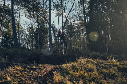 mountain bike rider jumping over gap