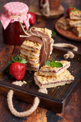 Pie bars with strawberry jam . Delicious homemade sweet dessert from shortcrust pastry. 