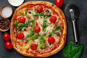 tasty italian pizza with mozzarella cheese, mushrooms, tomato, bell pepper, onion on a stone background
