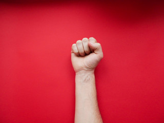 Feminism. Female fist on a red background.