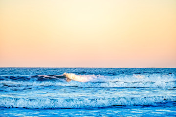 Orange sunset, sunrise with Waves on Ocean 